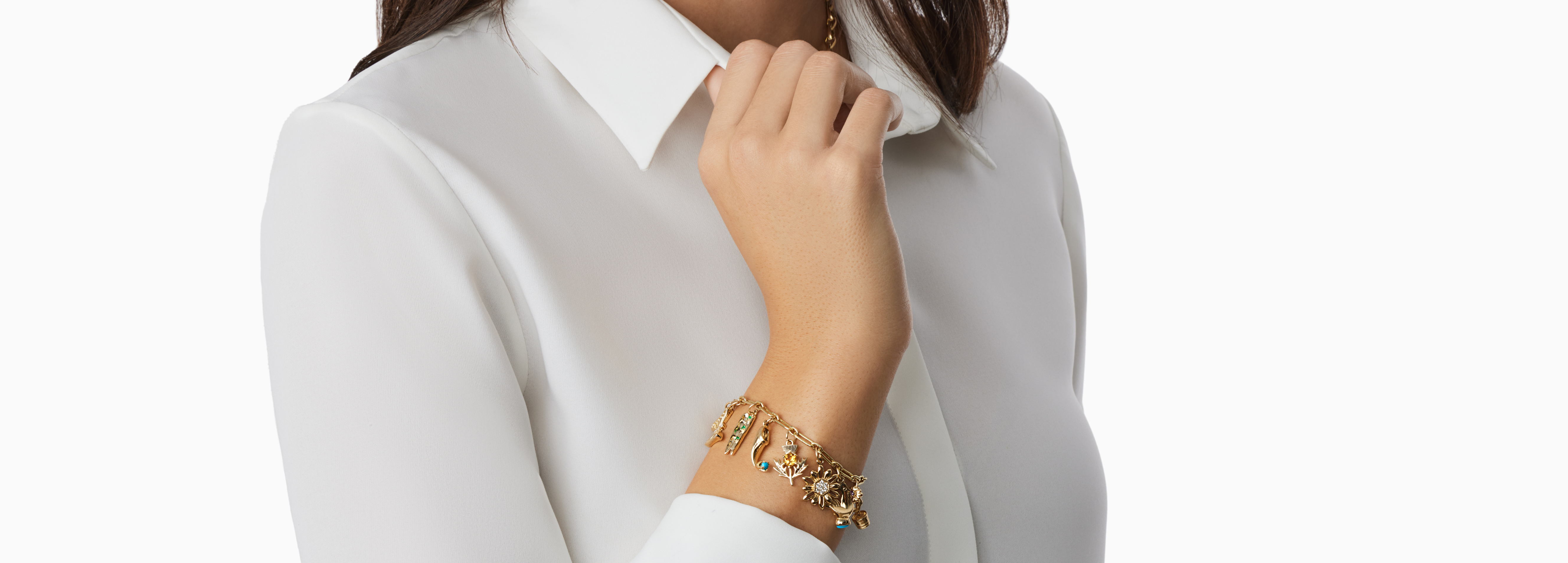 woman wearing collection of gemstone charms on chain around neck